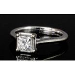 A modern 18ct gold white mounted diamond solitaire ring, the princess cut stone approximately .