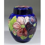 A Moorcroft pottery "Ginger" jar and cover, tube lined and decorated in colours with "Clematis"