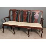 A walnut framed triple chair-back settee of George II design, the shaped crest rails with solid vase