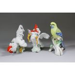 A pair of Spanish Algora porcelain figures of fighting cocks, 10ins and 10.5ins high (impressed