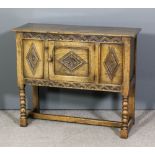 A panelled oak side cupboard of "17th Century" design with carved rails, enclosed by single door