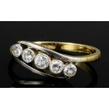 An early 20th Century 18ct gold and platinum mounted five stone diamond ring, the central old cut