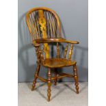 A 19th Century ash and elm two tier stick back Windsor armchair with arched crest rail, pierced