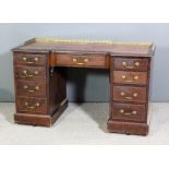 An Edwardian mahogany kneehole desk of Georgian design with recessed front and moulded edge to