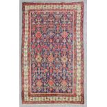 An antique Malayer long rug, woven in colours with endless stylised floral repeat on a dark blue