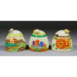 Three Clarice Cliff pottery honey jars and covers, comprising  - "Secrets (Fantasque)", "Autumn