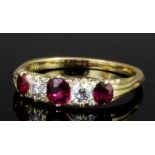 An 18ct gold mounted ruby and diamond five stone ring, the face set with a central oval cut ruby