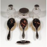 A George V lady's silver and tortoiseshell backed dressing table set comprising a pair of baluster