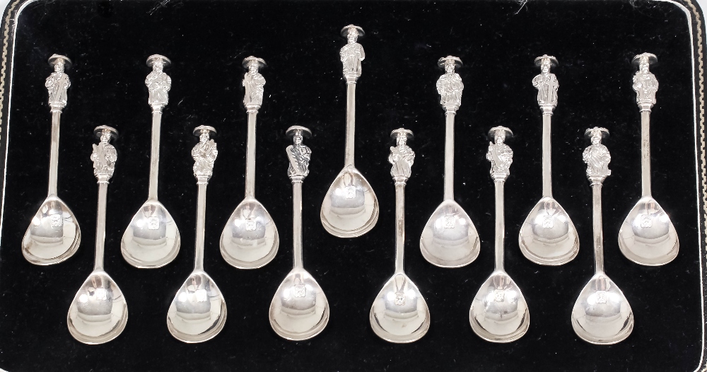 A set of thirteen George V silver apostle spoons, each with a cast terminal depicting a different