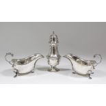 A pair of Elizabeth II silver sauce boats with gadroon mounts and flying C-scroll handles, each on