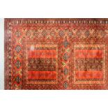 A modern Belgian machine made carpet of Tekke Ensi design woven in brown, blue, ivory and rose,
