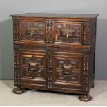 A late 17th/ early 18th Century panelled oak cabinet with twin split turned columns and raised