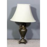 A bronzed metal two handled electric table lamp with caryatid pattern handles, 20ins high and