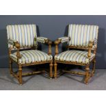 A pair of late 19th Century Continental walnut open armchairs, the seat back and armpads upholstered