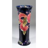 A Moorcroft pottery cylindrical vase of waisted form, tube lined and decorated in colours with "