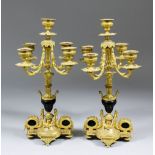 A pair of late 19th/early 20th Century Continental gilt brass five light candelabra with leaf mounts