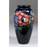 A Moorcroft pottery ovoid shaped vase tube lined and decorated in colours with "Anemone" design on a