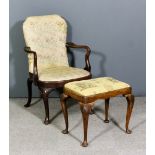 A walnut armchair of "Queen Anne" design with shepherd's crook arms, the back and seat upholstered