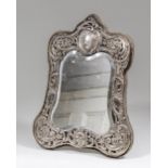 A late Victorian silver framed rectangular dressing table mirror of shaped outline, the silver