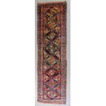 A Hamadan runner woven in colours with eight bold central medallions filled with geometric motifs