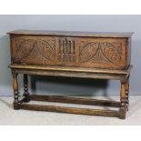 An old elm coffer, now with fall-front carved with lunette leafage and stop fluted ornament, on