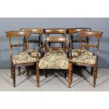 A set of five William IV rosewood dining chairs with plain curved crest rails, carved splats, drop