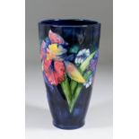 A Moorcroft pottery vase of tapering form, tube lined and decorated in colours with "Orchid" design,