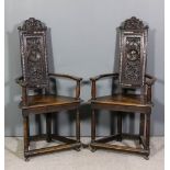 A pair of 19th Century carved and panelled oak armchairs, 16th Century Caqueteuse design, the shaped