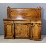 A Victorian mahogany sideboard with shaped panel to back, the base fitted three drawers with