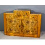 A 1930's walnut and figured walnut sideboard/ cocktail cabinet the central section opening to reveal