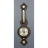 A Victorian rosewood wheel barometer, thermometer and hydrometer by Hayward of Ashford, the 8ins