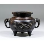 A Chinese bronze two-handled censer, the sides cast with a figure beside Buddha and waterlilies