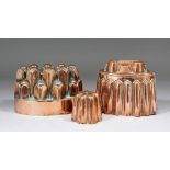 Three Victorian copper jelly moulds, the first of oval form with plain rim and two tier stepped