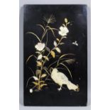 A Japanese lacquer and shibyama panel depicting a dove amid flowers and grasses, the details in gold