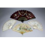 A French horn and silk fan, the silk panel painted with a seated muse making music within a