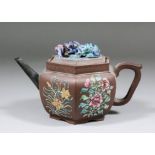 A Chinese Yixing stoneware teapot, the panelled sides enamelled in colours with flowering