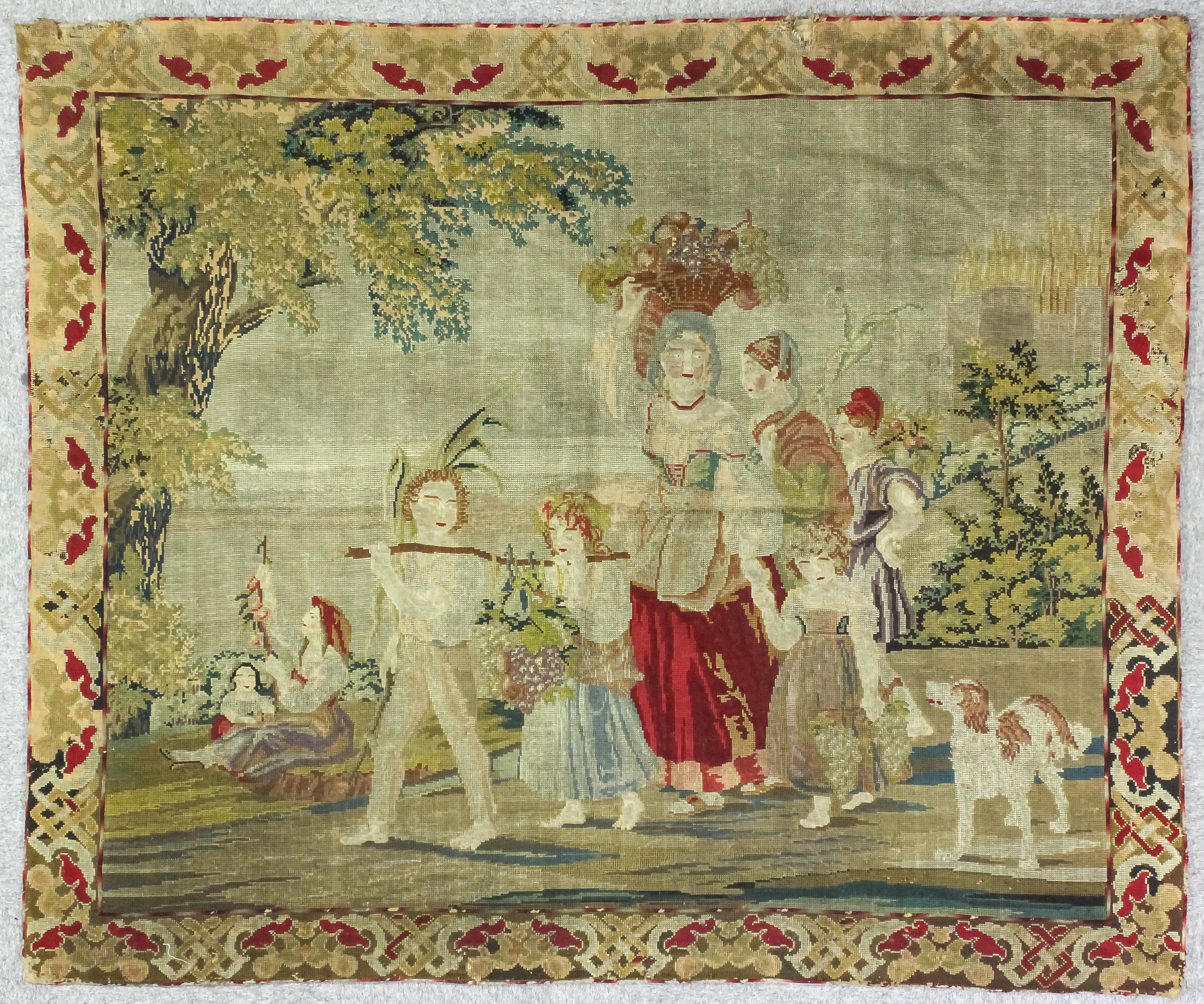 A 19th Century Berlin woolwork wool hanging depicting a group of women and children with spaniel