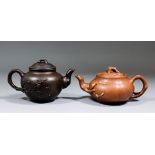 A Chinese Yixing stoneware teapot of dark brown colour, the body moulded with prunus blossom and