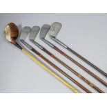 Four golf clubs by John Sinclair Fernie - No. 1 iron, No. 2 irons (two), and No. 3 iron, and a ditto