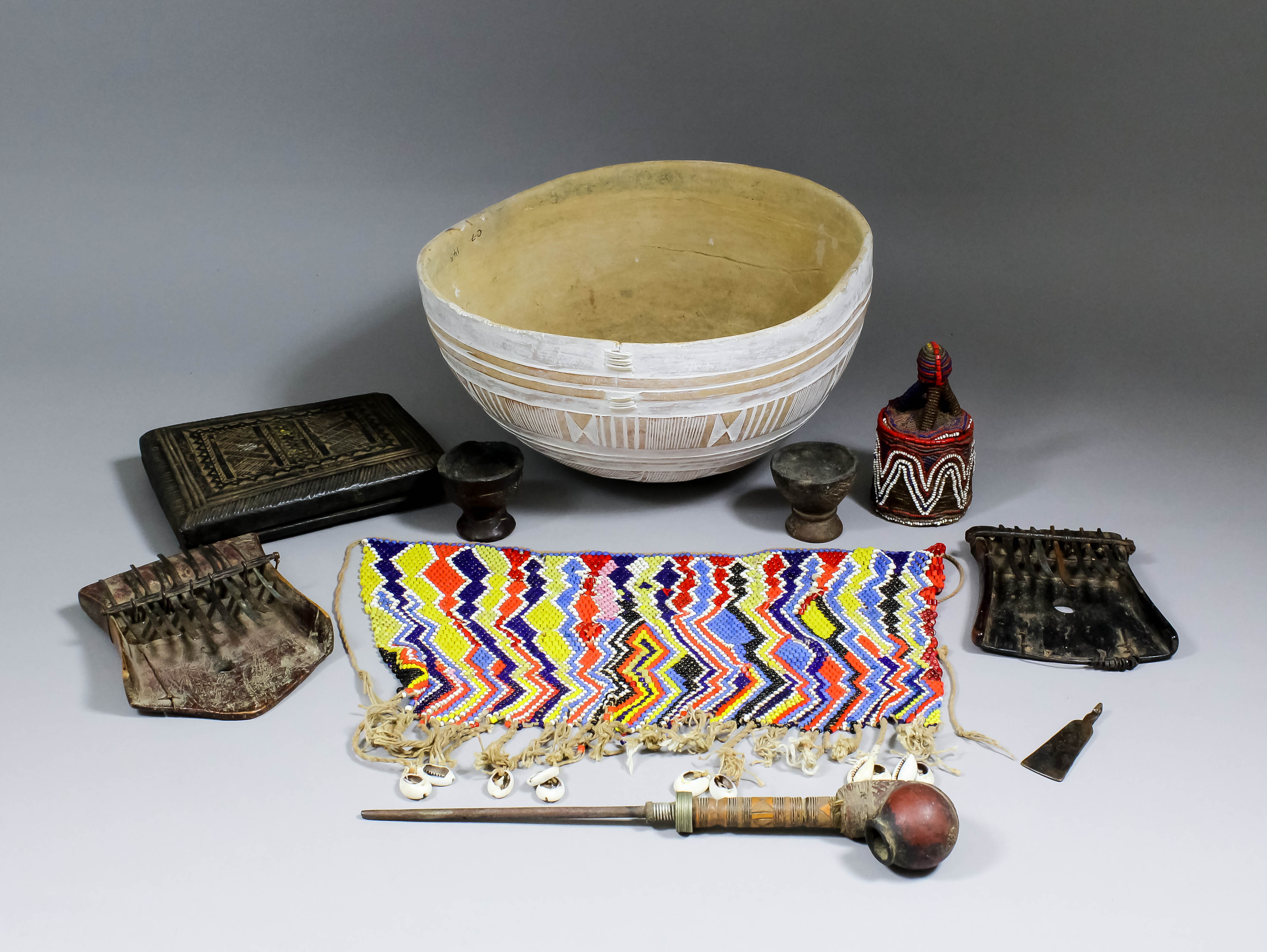 A small collection of artifacts, comprising - 19th Century Nupe (Northern Nigeria) carved wood