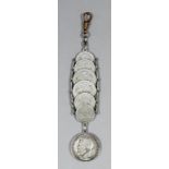 An Imperial Russian silvery metal watch fob formed of two 10, two 15 and two 20 Kopek coins dated