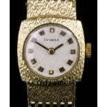 A 1950s lady's 14ct gold Dugena wristwatch, the white face with baton numerals, contained in plain