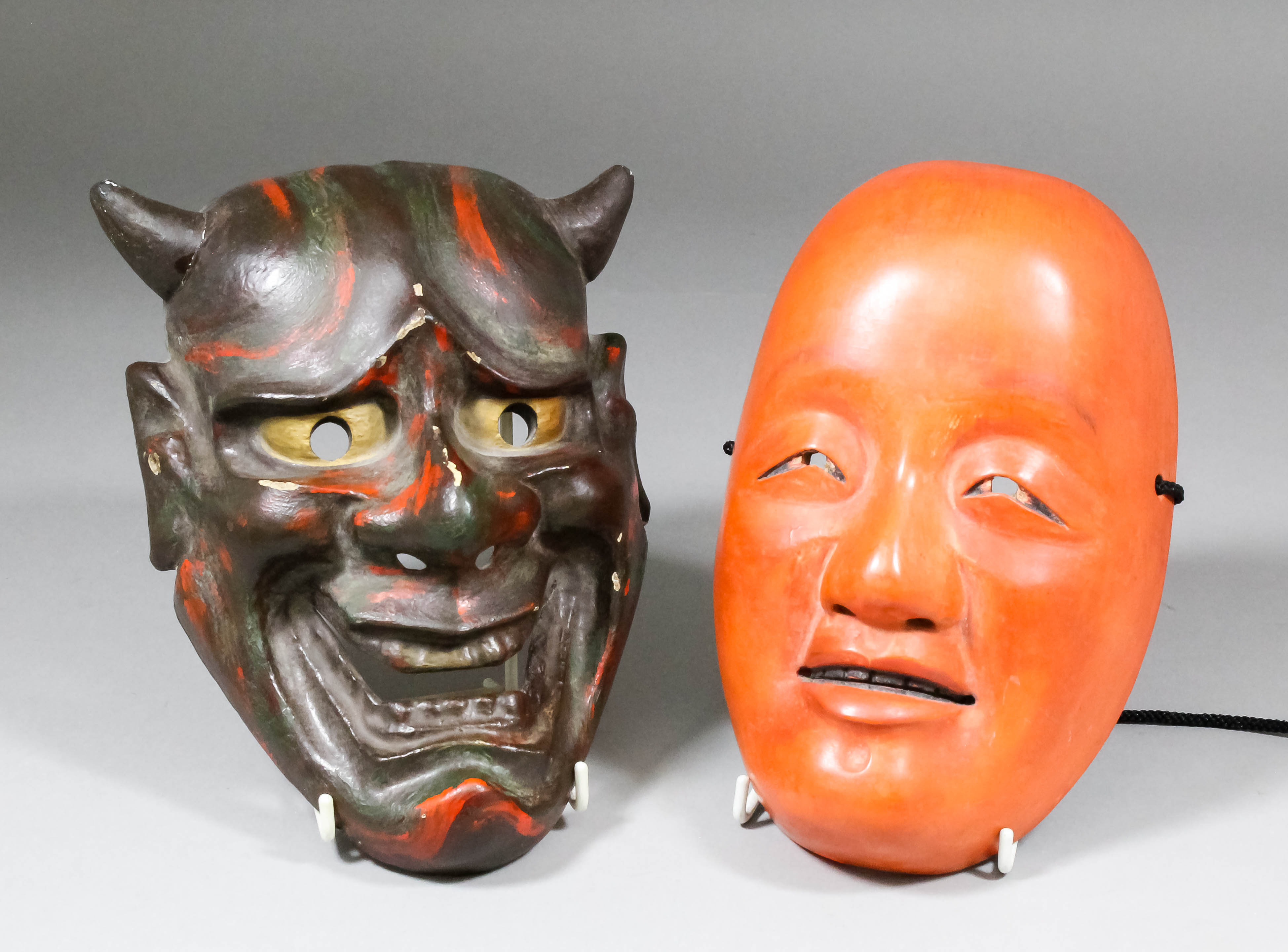 A Japanese carved and painted laquer No mask of a Shojo (Japanese sea spirit with a red face, long