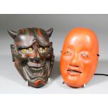 A Japanese carved and painted laquer No mask of a Shojo (Japanese sea spirit with a red face, long