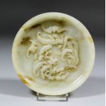 A Chinese celadon jade circular shallow dish with some brown inclusions, the interior finely