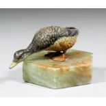 An early 20th Century cold painted metal figure of a goose mounted on an hexagonal onyx base, 2ins