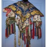 A Chinese child's bride's silk cape, finely embroidered in coloured silks with moths and