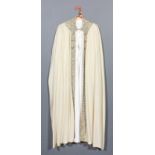 An Egyptian ivory cloth full length cloak with silver wirework embroidered neck and edge panels,