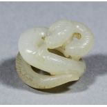 A small Chinese white jade carving of a coiled snake, 71mm diameter x 16mm high