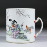 A Chinese "Famille Rose" Export porcelain tankard enamelled with two courtiers in a garden and